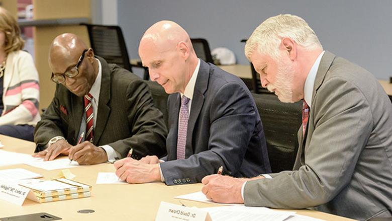 Drs. Chown, Sygielski, and Achampong sign articulation agreements.