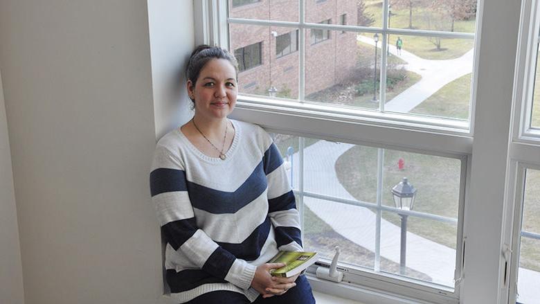 Female student sits in window